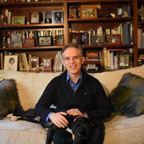 Gordon Achtermann at home with his dog, Sirius